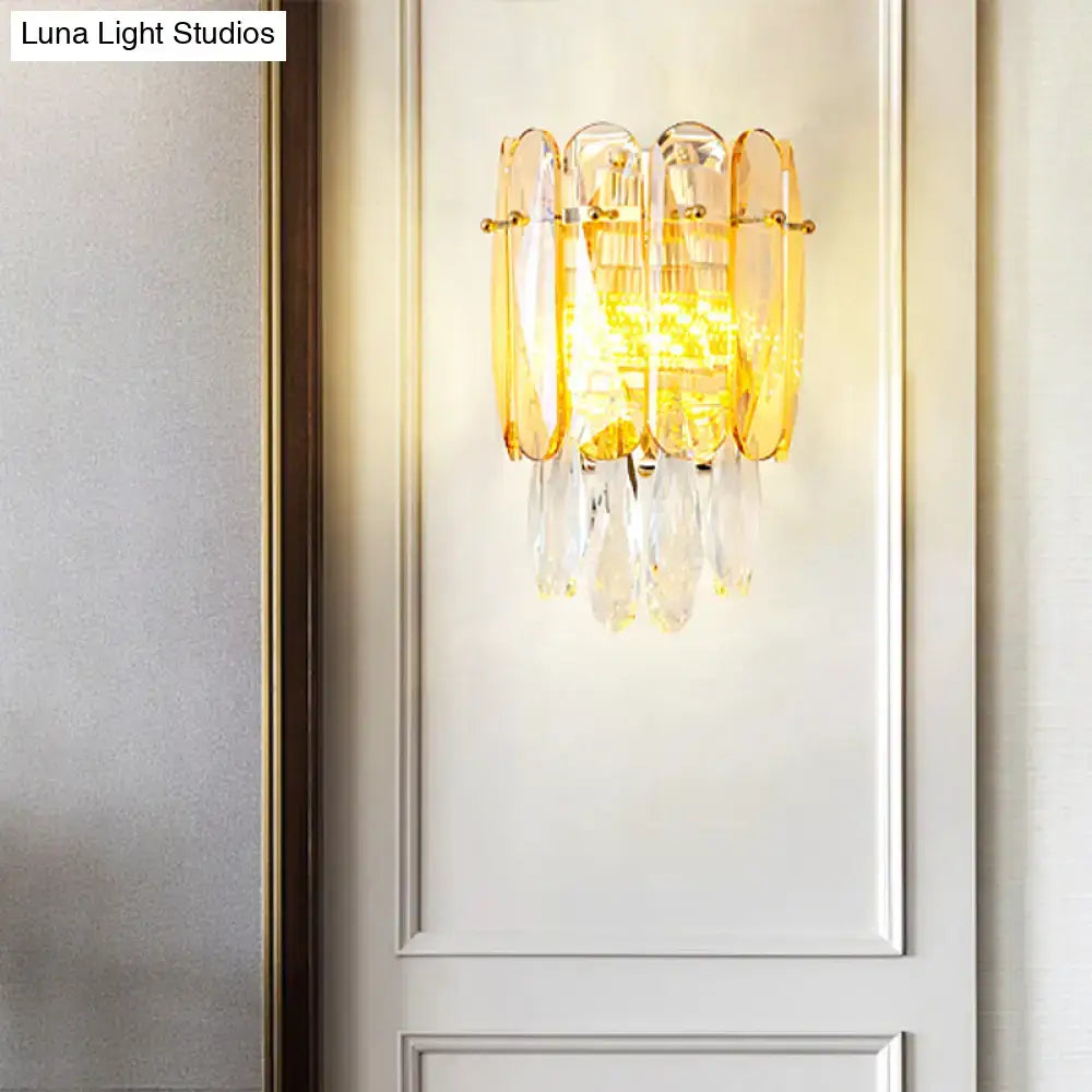 Elegant gold-toned postmodern sconce light with faceted crystal droplets and amber glass panels for bedroom wall light