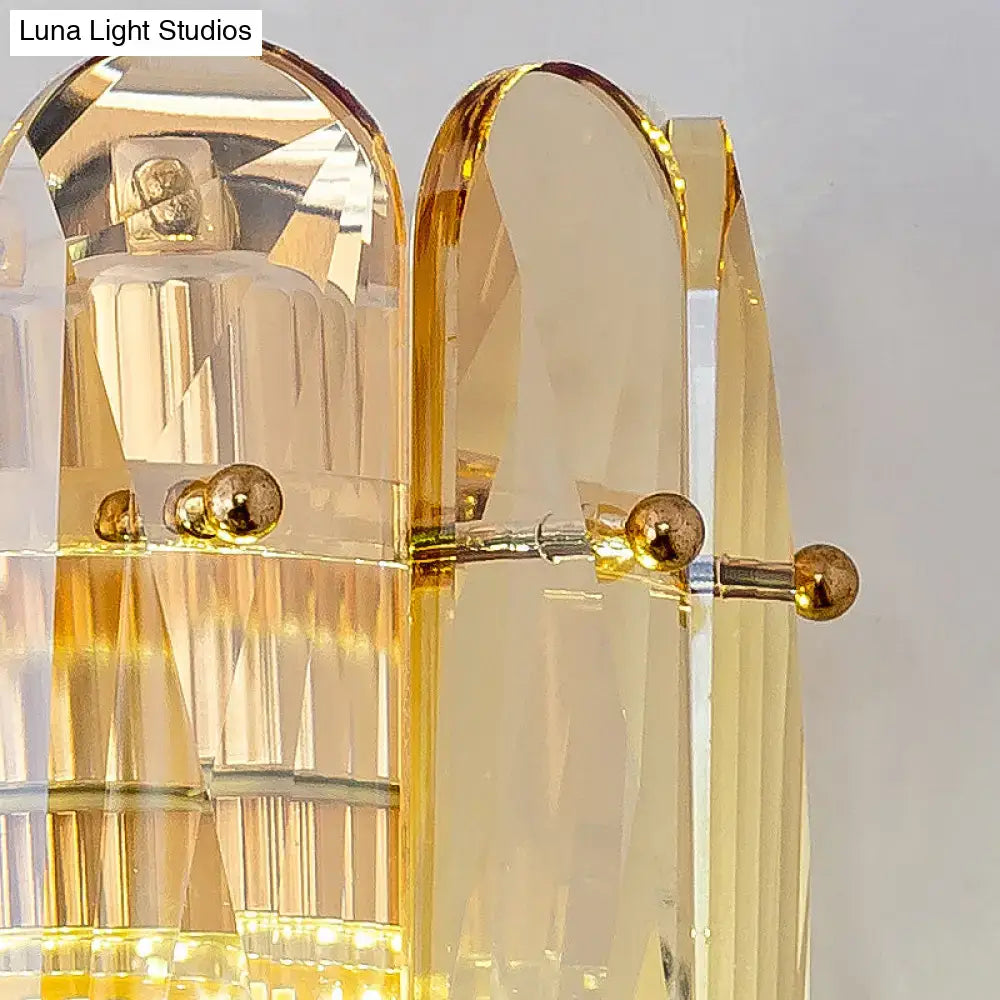 Postmodern gold faceted crystal sconce light with golden acrylic ribbed panels and brass accents for bedroom wall light