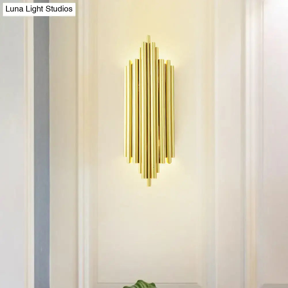 Postmodern gold finish flute wall mount living room sconce with gold-toned vertical cylindrical tubes in symmetrical pattern