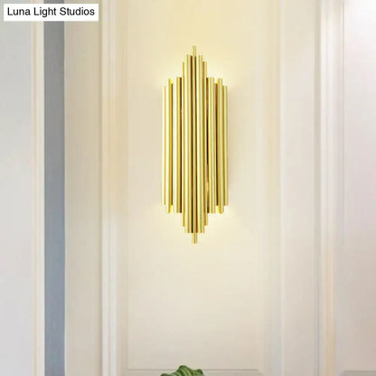 Postmodern gold finish flute wall mount living room sconce with gold-toned vertical cylindrical tubes in symmetrical pattern