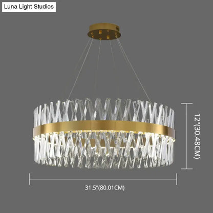 A postmodern gold finish pendant light with geometric k9 crystal elements and an interlocking circular frame fixture width