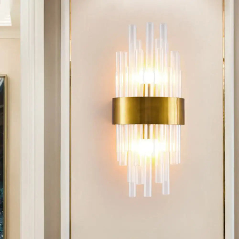 Postmodern gold-toned wall sconce with clear fluted crystal rods and a circular base designed for 110v-120v use