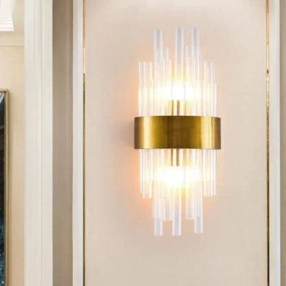 Postmodern gold-toned wall sconce with clear fluted crystal rods and a circular base designed for 110v-120v use