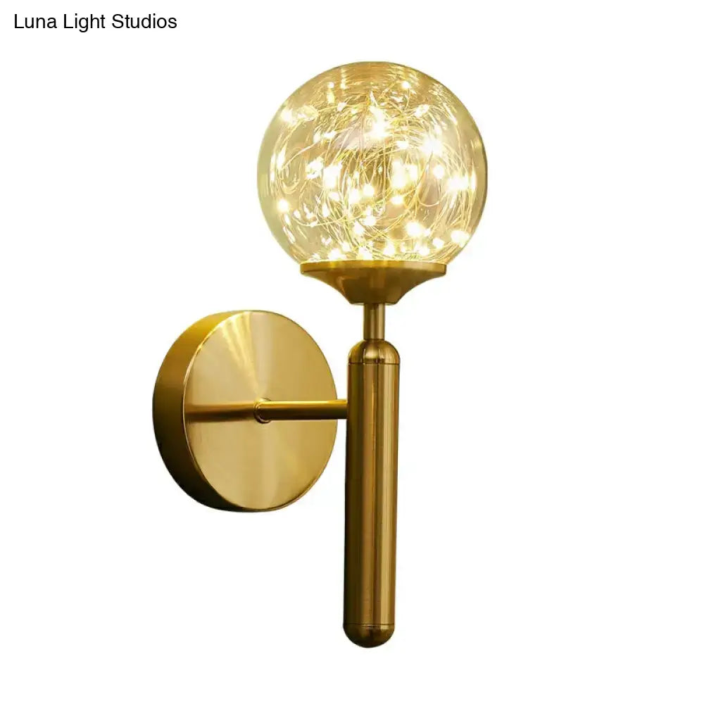 Postmodern gold glass globe wall light fixture with warm fairy lights designed as a spherical wall light fixture