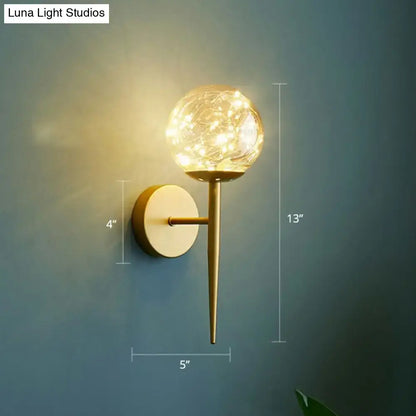 Postmodern gold glass globe wall light fixture with warm led fairy lights as a stylish bedroom wall light fixture