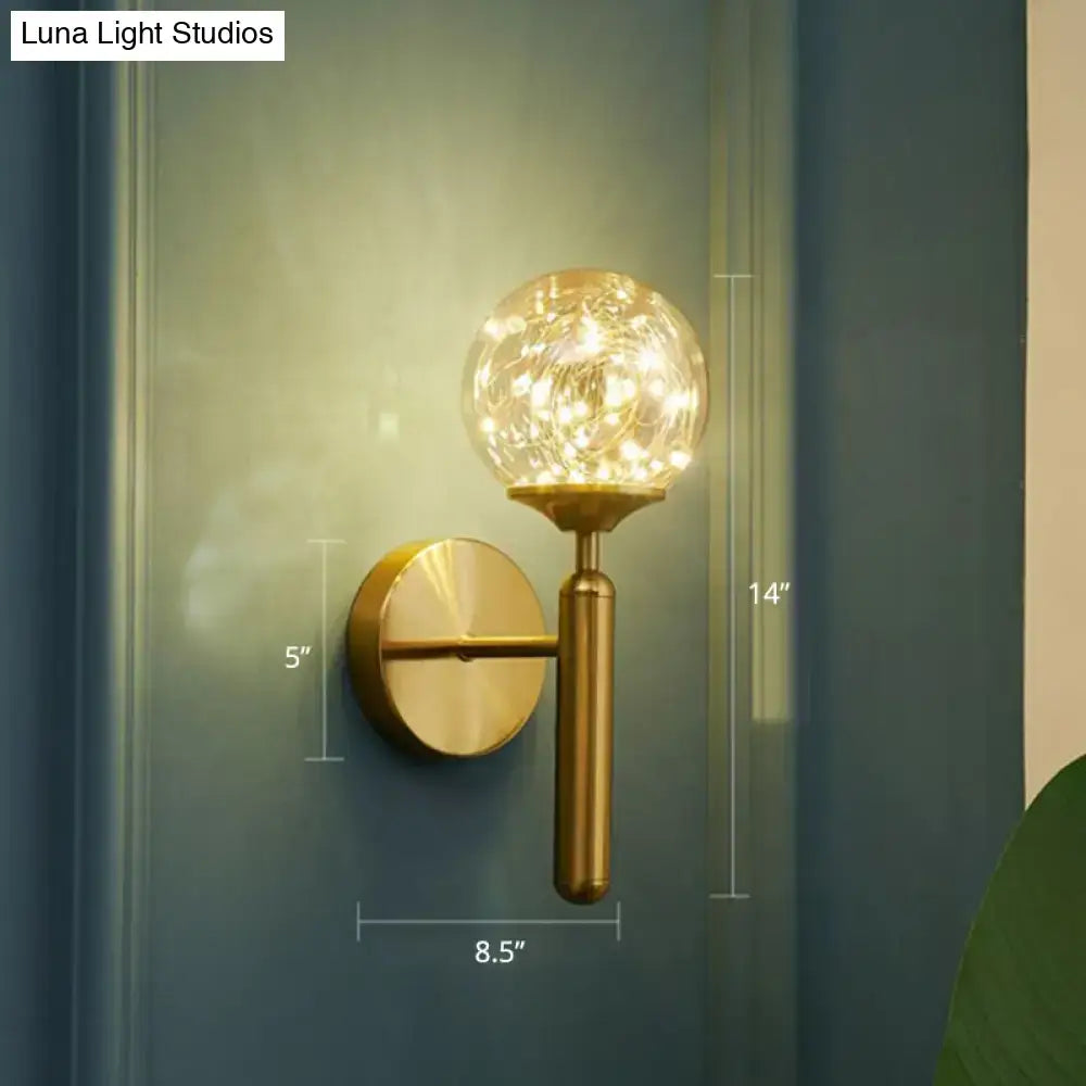 Postmodern gold glass globe wall light fixture with warm fairy lights designed as a starry led wall light for bedroom