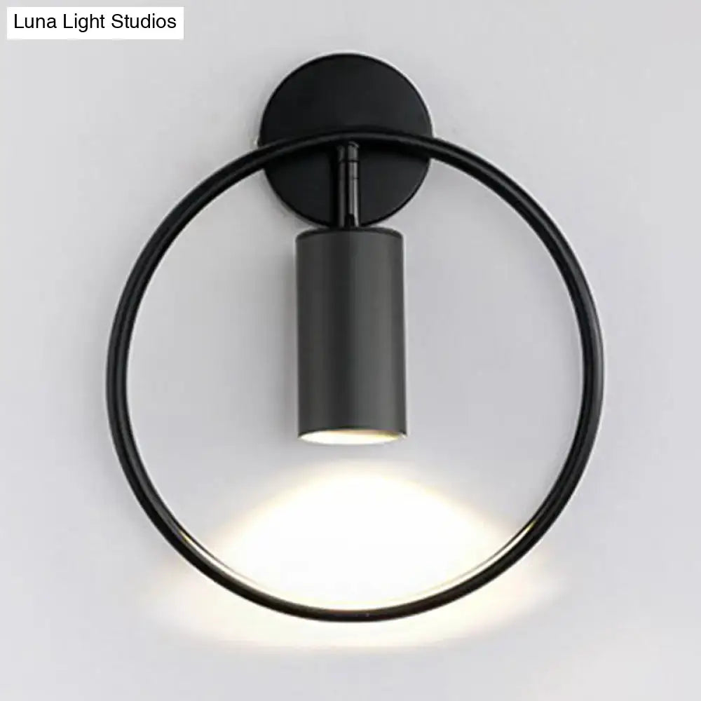 Black minimalist wall sconce with circular ring and cylindrical light fixture featuring 16 inches fixture height