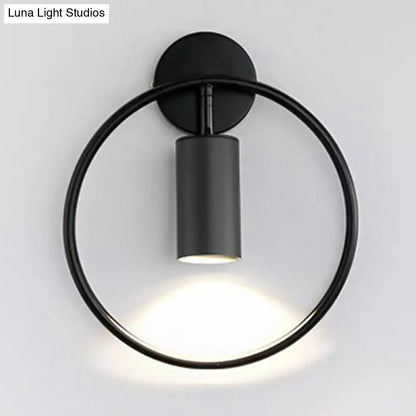 Black minimalist wall sconce with circular ring and cylindrical light fixture featuring 16 inches fixture height