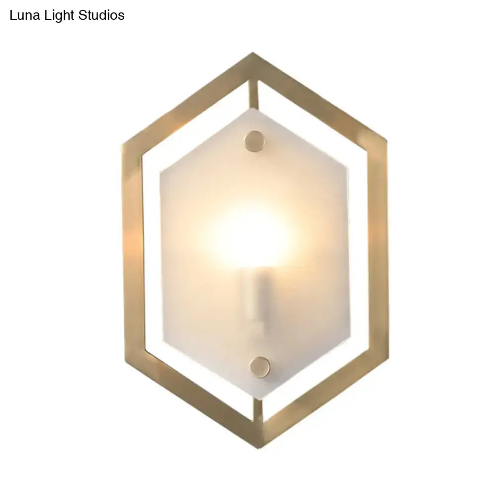 Gold-toned hexagonal wall lamp with frosted glass shade minimalist sconce lighting for bedroom use