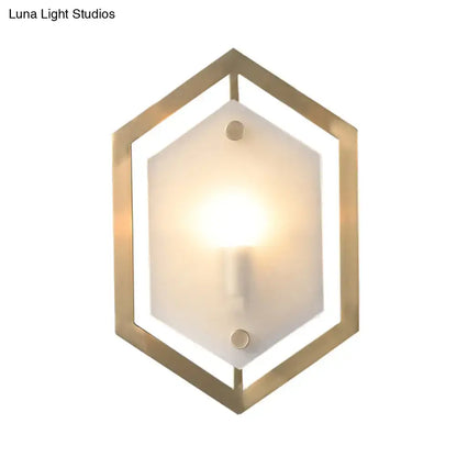 Gold-toned hexagonal wall lamp with frosted glass shade minimalist sconce lighting for bedroom use