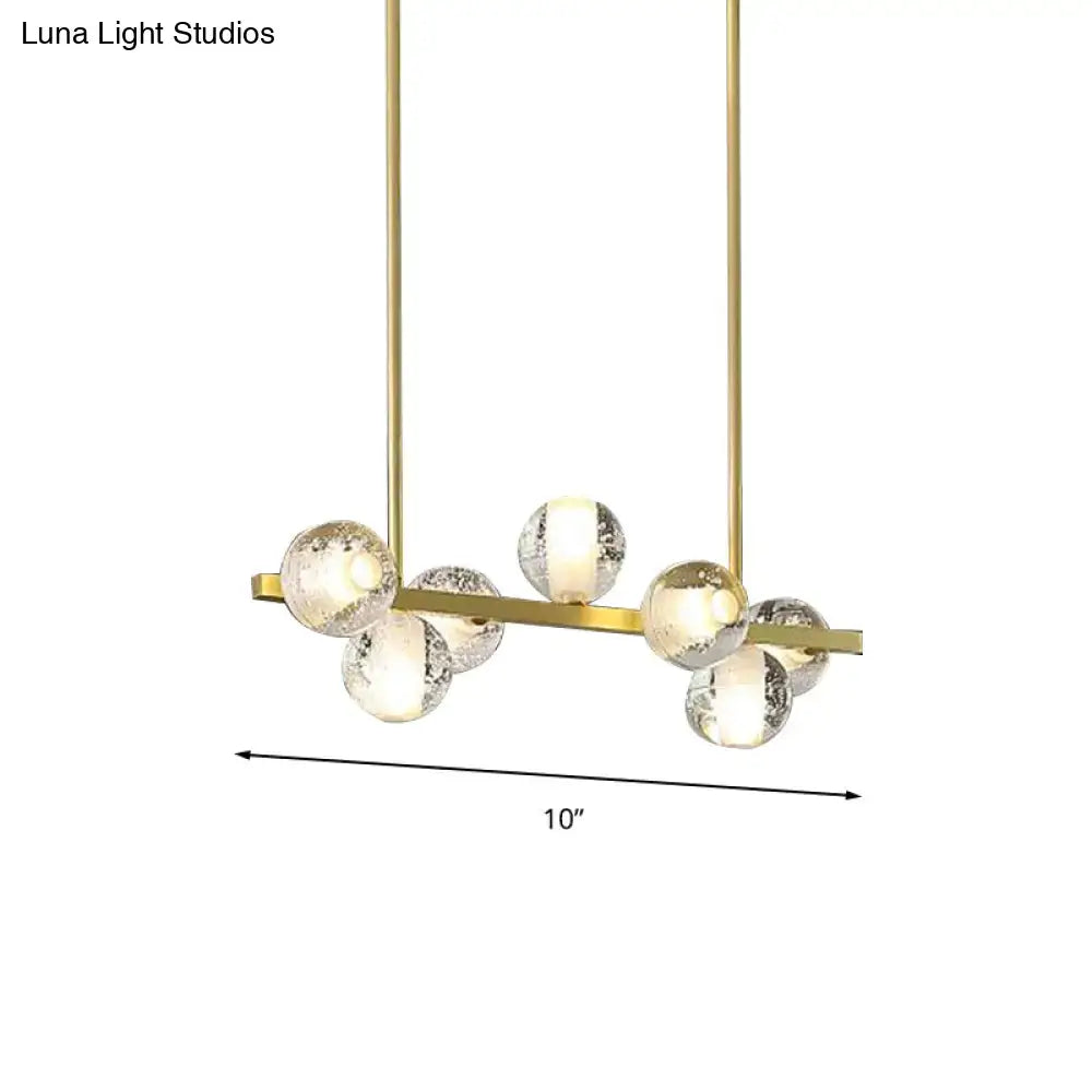 Gold-toned DecorBites postmodern pendant light with 6 seeded crystal suspension globes ideal for dining rooms