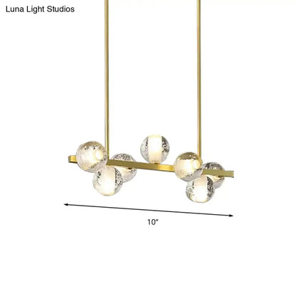 Gold-toned DecorBites postmodern pendant light with 6 seeded crystal suspension globes ideal for dining rooms