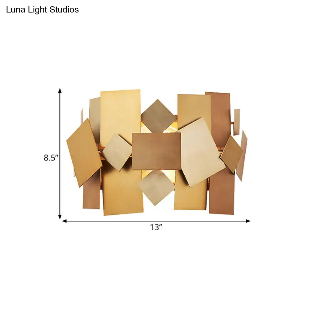 Postmodern gold stacked panel sconce light fixture with overlapping bronze and gold metallic rectangular panels for living room
