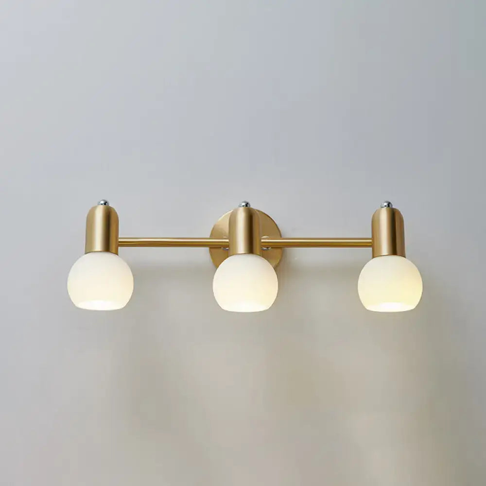 Postmodern gold swivel dome milk glass vanity light with three frosted globe bulbs wall-mounted for bathroom use
