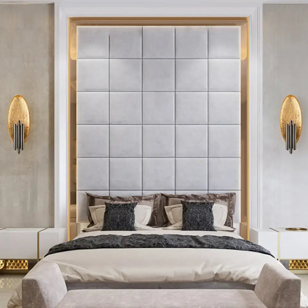 The bed with a tufted light gray upholstered headboard is paired with matching nightstands and a postmodern led oblong wall lamp feature for bedroom 110v-120v