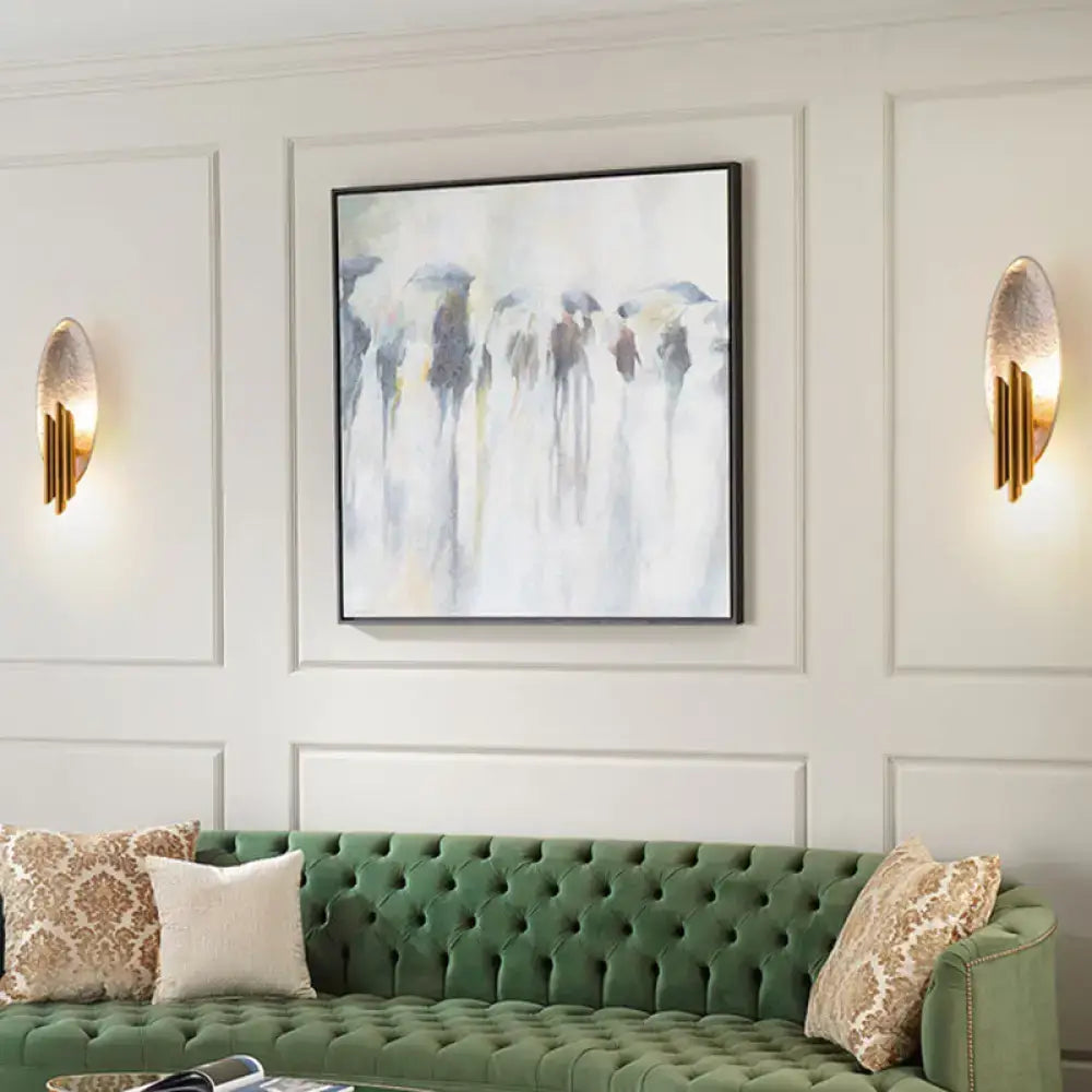 Green tufted velvet sofa with decorative throw pillows under postmodern led oblong wall lamp feature 110v-120v use