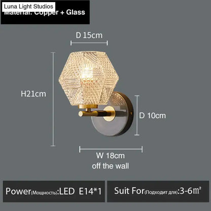 A postmodern luxury led wall lamp with a hexagonal gold crystal glass shade and copper mounting bracket for bedroom use