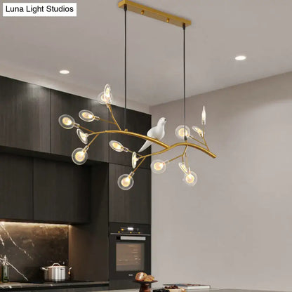 DecorBites postmodern metal island light with gold-toned branch design, clear globe bulbs, and white ceramic bird hanging lamp