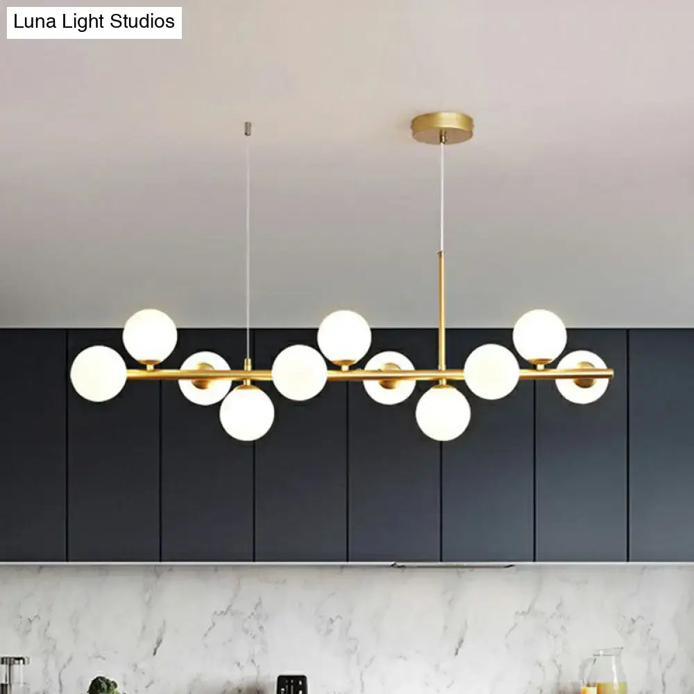 DecorBites™ LED island pendant light features modern gold-toned fixture with smoke grey cognac frosted glass globes