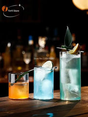 Three tall clear glass highball cups filled with colorful drinks and garnished with lime and leaves in a highball cup set