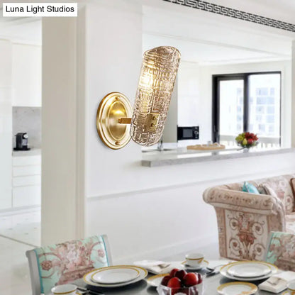 Gold-toned wall light with a textured translucent prism glass shade designed for corridor lighting