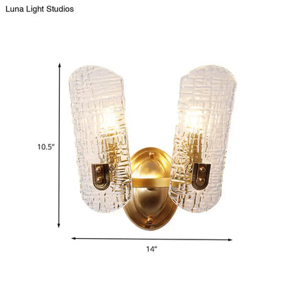Gold-toned wall light with two textured translucent glass shades featuring a woven pattern for corridor use