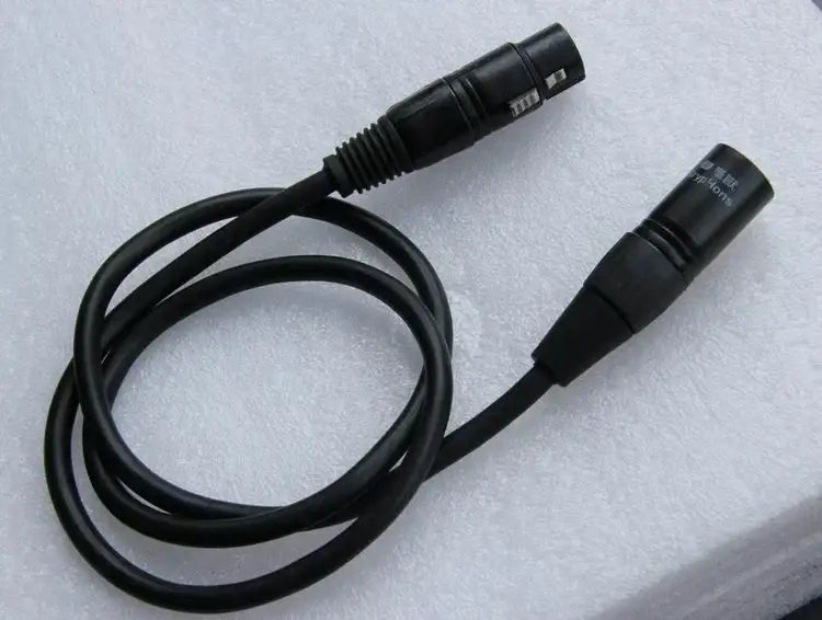 Professional black shielded dmx cable with two male connectors coiled on white foam for stage lighting use