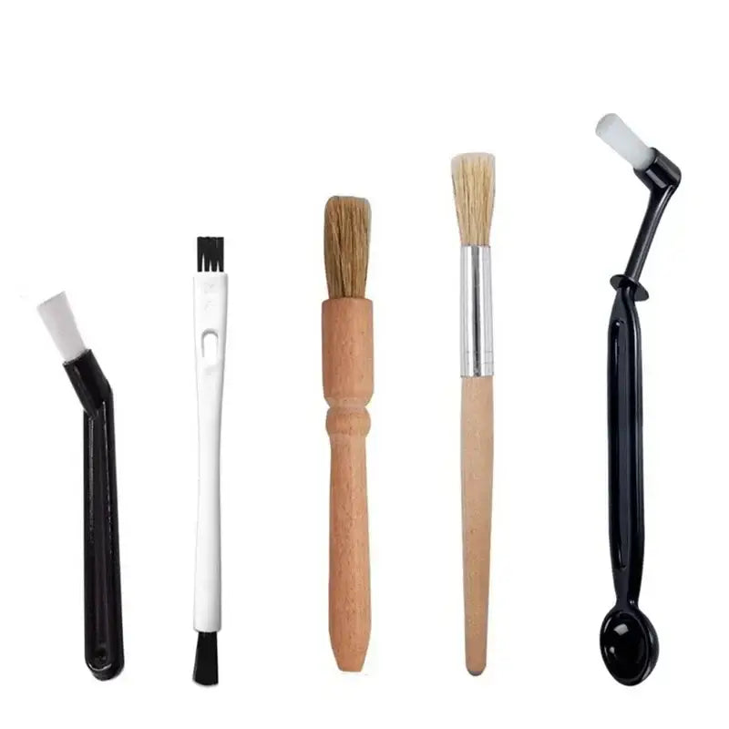 Set of five professional coffee machine cleaning brushes with varied bristles and black plastic, white plastic, and wood handles