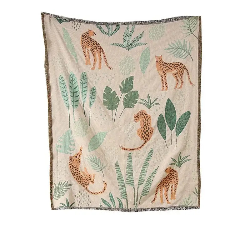 Beige woven ethnic tapestry sofa blanket with orange cheetahs green tropical leaves and textured fringe for living room