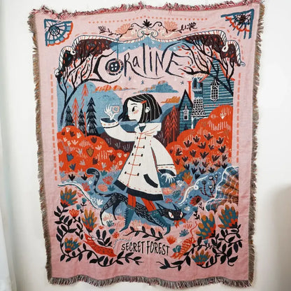 Pink woven ethnic tapestry sofa blanket with fringed edges featuring colorful coraline design for living room use
