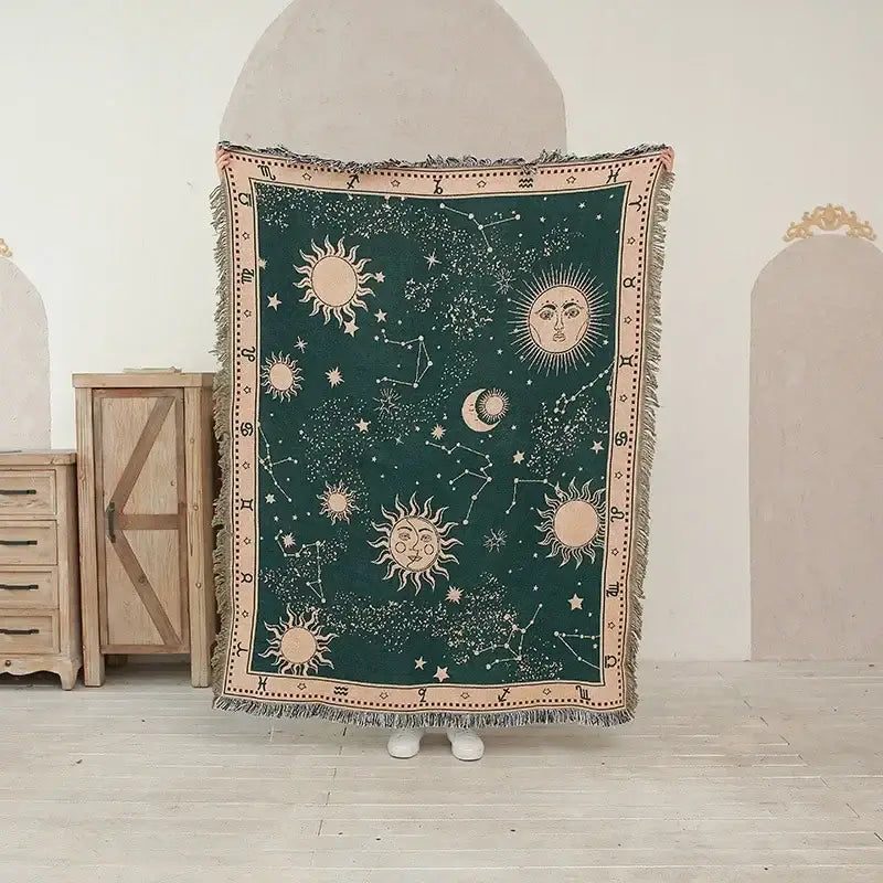 Dark green woven ethnic tapestry sofa blanket with embroidered celestial designs for olive and pink living room decor