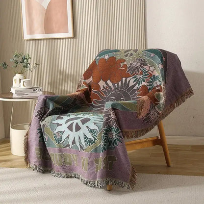 Cozy multicolored ethnic tapestry sofa blanket with vibrant floral sun motif and fringed edges in olive and pink tones