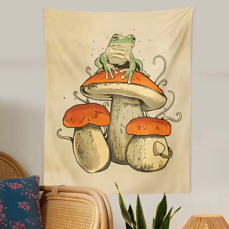 Beige tapestry with a green frog perched on orange-capped mushrooms featuring whimsical decorbites frog mushroom details