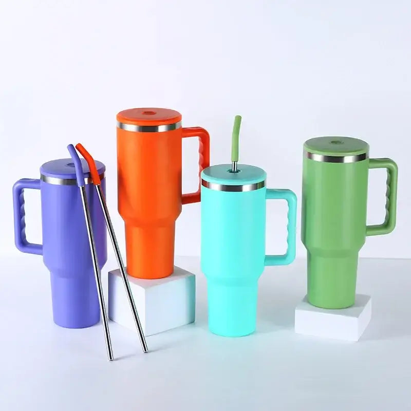Four colorful insulated stainless steel sippy cups with handles and straws in purple, teal, orange, and green for travel