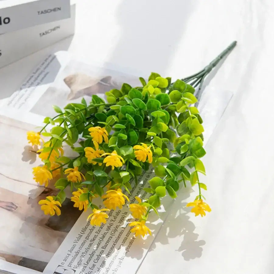 A vibrant yellow plastic flower bouquet with green leaves for decorbites artificial eucalyptus plant wedding decor