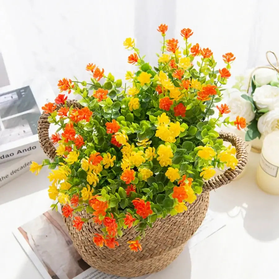 A vibrant artificial eucalyptus plant by decorbites featuring orange and yellow plastic flowers in a wicker basket decor