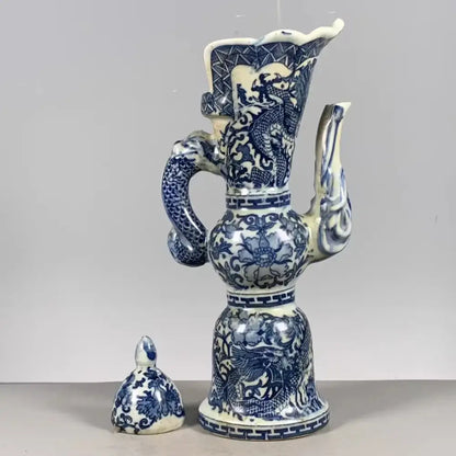 Qing blue and white porcelain ewer with intricate white dragon pattern and serpentine handle for living room decor