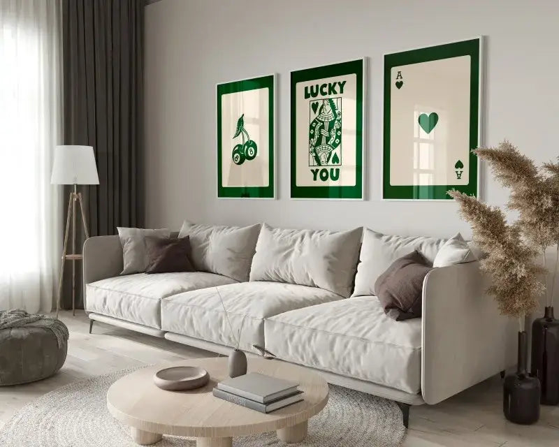 Decorbites lucky queen of hearts canvas wall art set featuring three framed green and cream hearts canvas above gray sofa