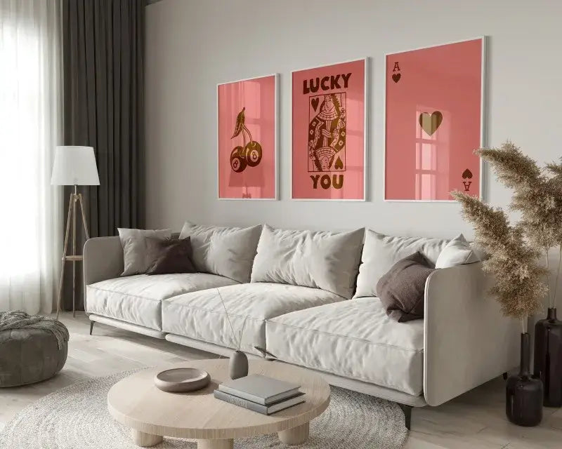 A modern beige sectional sofa with plush cushions and dark gray throw pillows next to the decorbites™ 3-piece retro hearts wall art set
