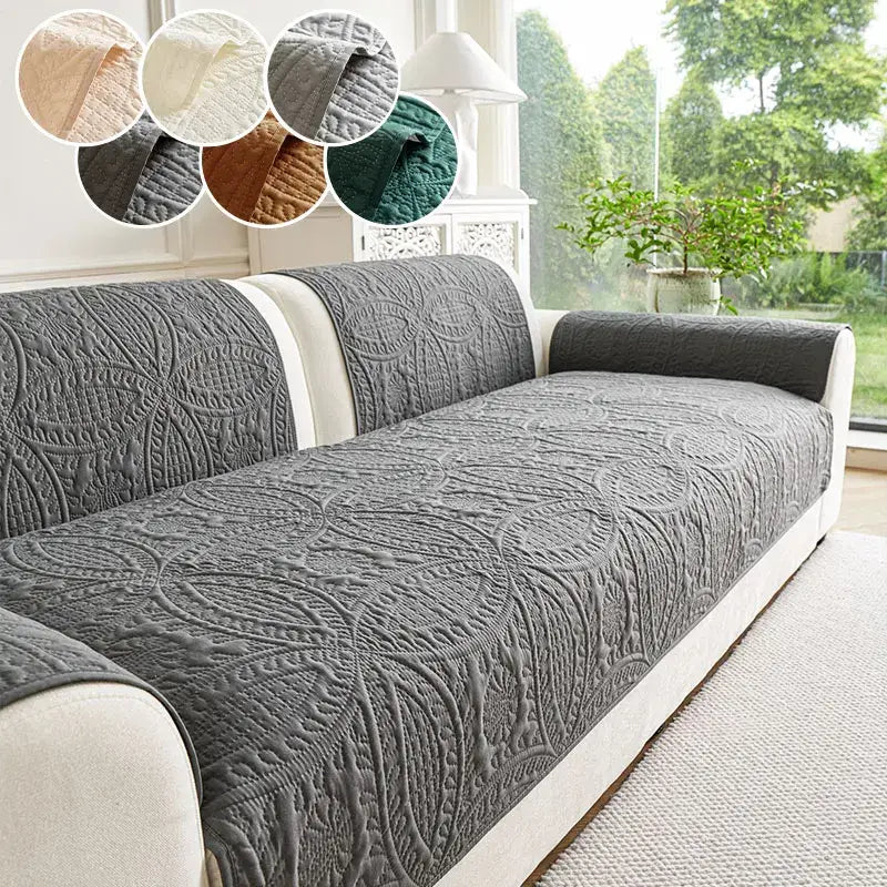 Gray quilted sofa cover with intricate floral embroidery designed for living room cushion protection