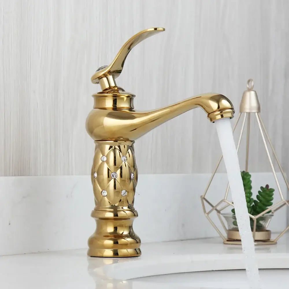 Golden plated bathroom basin faucet with quilted diamond decorbites body and elegant curved spout in gold color