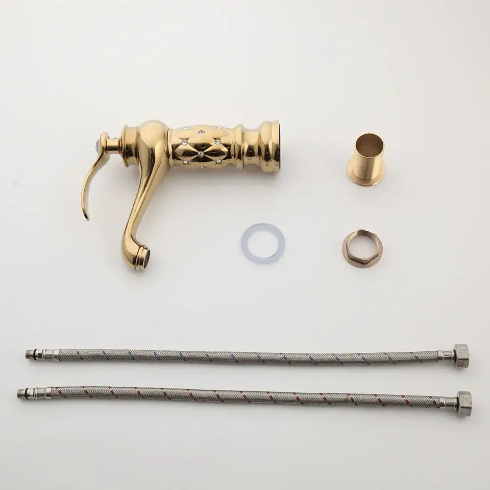 Gold-colored decorbites golden plated bathroom basin faucet with ornate diamond engraving and braided metal hoses
