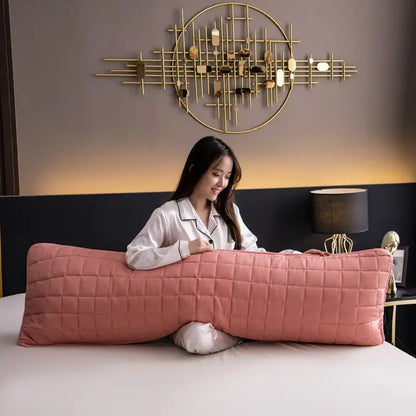 A long pink quilted body pillow with diamond-stitch pattern in a decorbites colorful decorative pillowcase cover