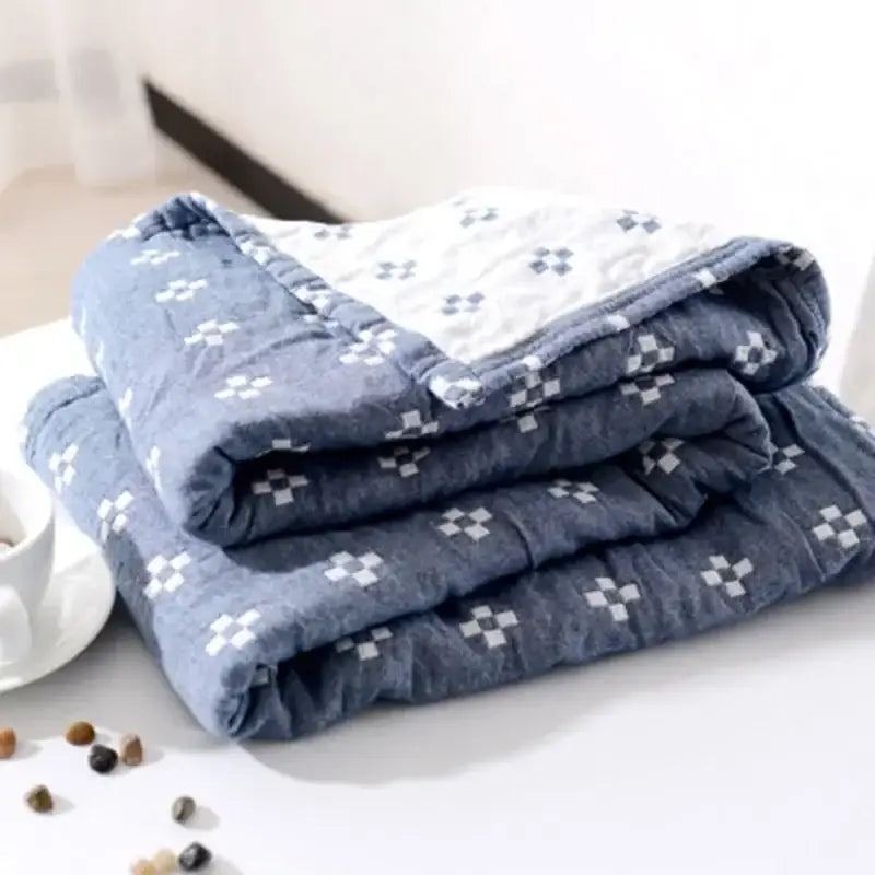 Stacked blue quilt sofa cover with white crosshatch pattern and soft plush texture decorbites cotton gauze sofa throw