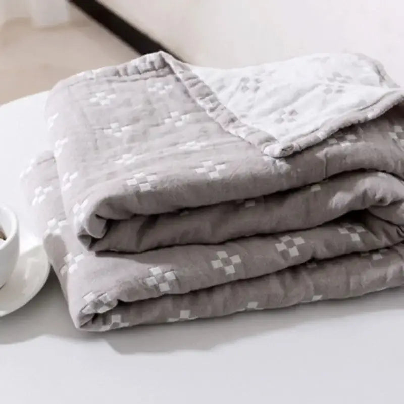 Stacked gray quilted cotton gauze sofa cover with subtle white checkered pattern for living room decorbites cotton gauze