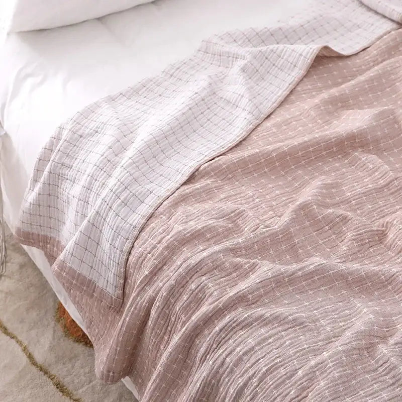 A soft pink and white quilted grid cotton gauze sofa cover perfect as decorbites cotton gauze living room throw blanket