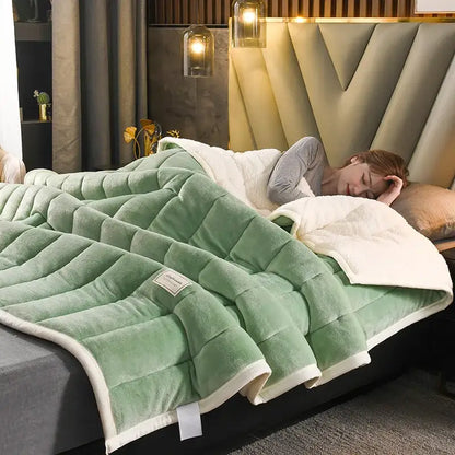 A quilted green and white cozy coral fleece bed blanket with a plush texture and diamond stitch pattern by decorbites