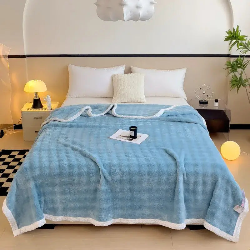 Light blue quilted throw blanket with soft plush texture and white fleece trim made from decorbites imitation rabbit velvet