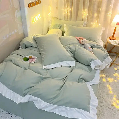 Soft sage green duvet cover set with white ruffled trim and matching pillowcases for cozy bedroom bedding