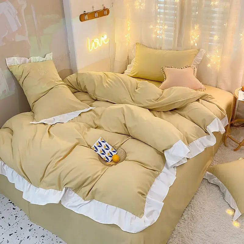 Cozy mustard-yellow duvet cover set with white ruffled trim and matching pillows in a warmly lit bedroom setting